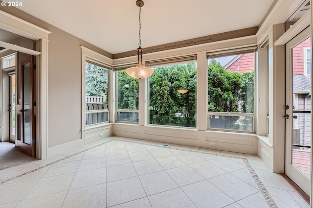 unfurnished dining area with a wealth of natural light and light tile patterned floors