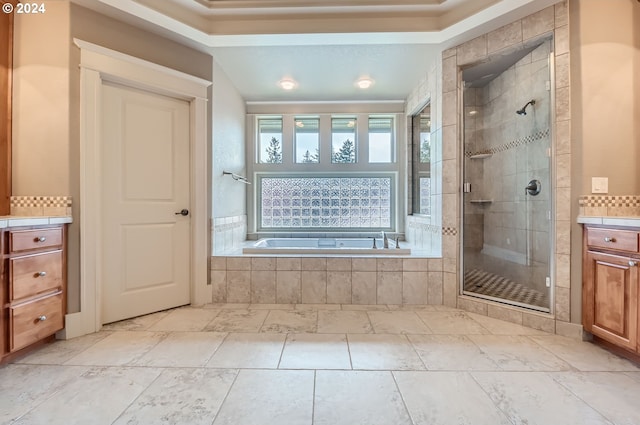 bathroom with vanity and separate shower and tub