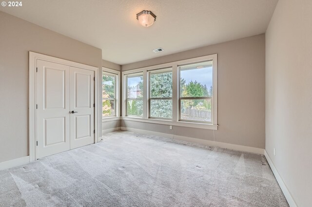 unfurnished bedroom featuring a closet and carpet floors