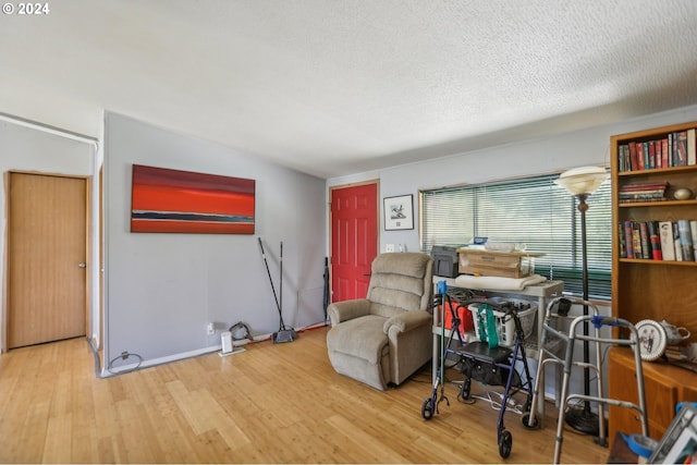 sitting room with a textured ceiling and light hardwood / wood-style floors