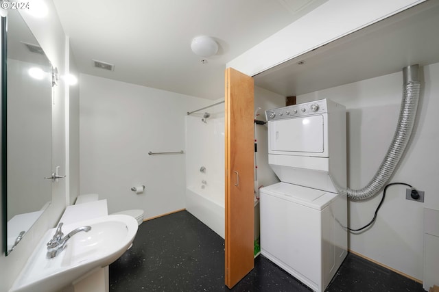 full bathroom with shower / washtub combination, toilet, stacked washer / dryer, and sink