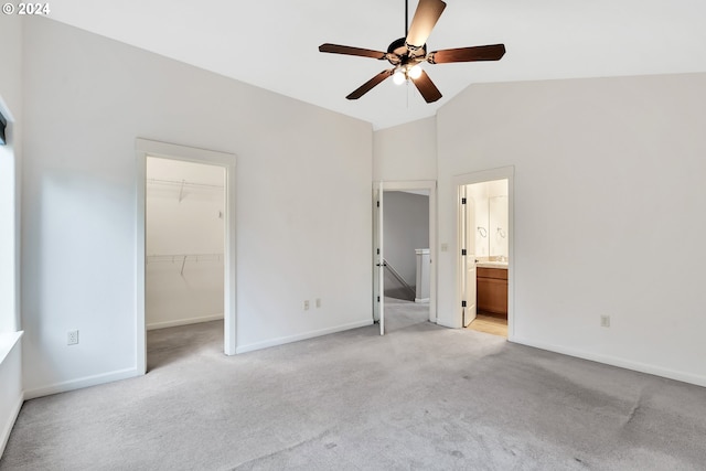 2067 NE 49th Way, Hillsboro, OR 97124 - unfurnished bedroom with light carpet, vaulted ceiling, a spacious closet, baseboards, and ensuite bath