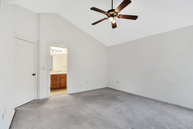2067 NE 49th Way, Hillsboro, OR 97124 - unfurnished bedroom featuring light colored carpet, vaulted ceiling, baseboards, connected bathroom, and ceiling fan