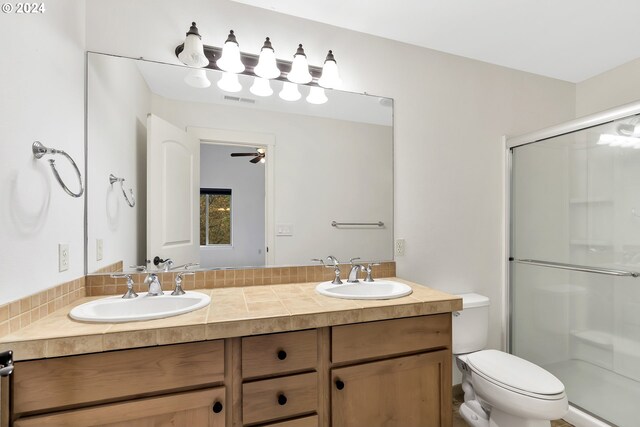 2067 NE 49th Way, Hillsboro, OR 97124 - bathroom featuring a shower stall, toilet, double vanity, and ceiling fan