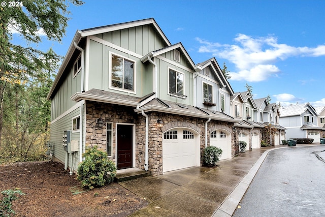 2067 NE 49th Way, Hillsboro, OR 97124 - view of front of house with an attached garage, board and batten siding, driveway, and stone siding