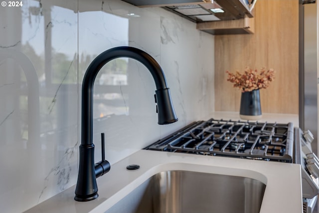 interior details featuring sink and tasteful backsplash