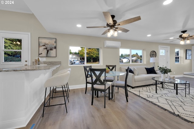 living room with ceiling fan, a wealth of natural light, and light wood-type flooring