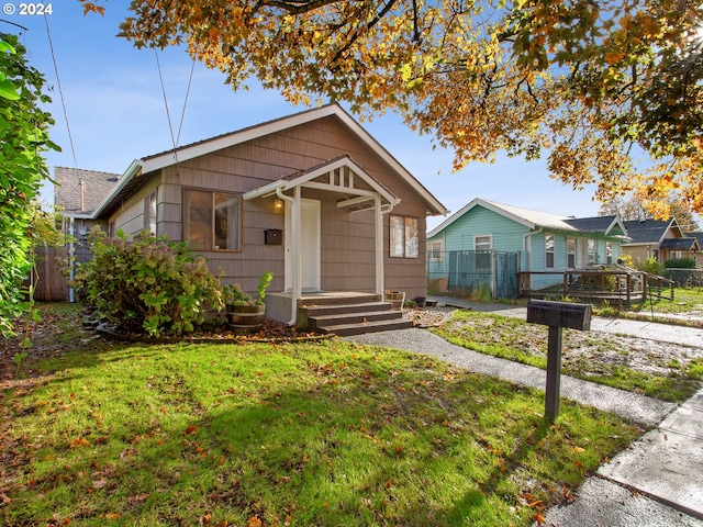 bungalow-style house with a front yard