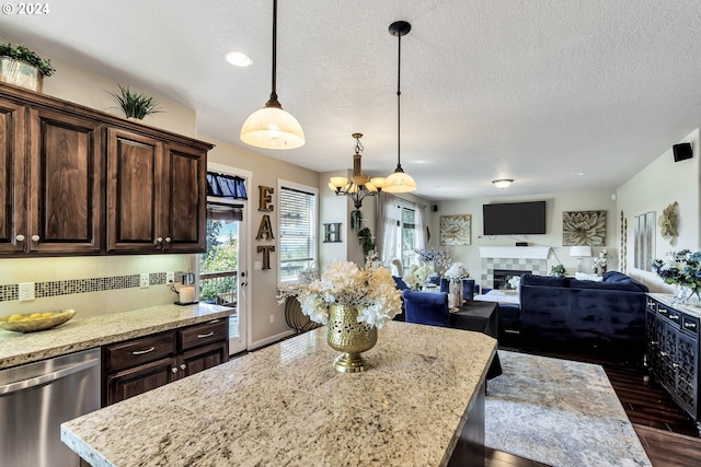 kitchen featuring dark brown cabinetry, a fireplace, dishwasher, and dark hardwood / wood-style flooring