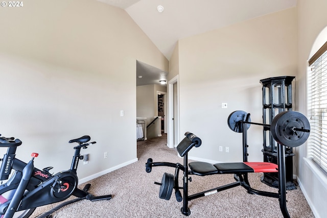 workout room with vaulted ceiling and carpet floors