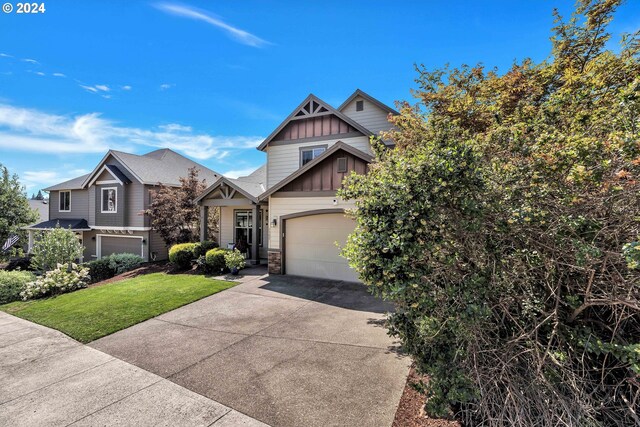 craftsman-style house with a garage and a front lawn