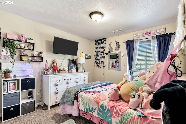 carpeted bedroom featuring a textured ceiling