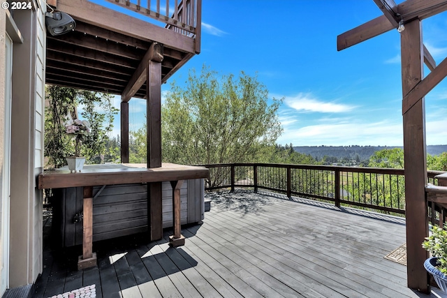 wooden deck with a hot tub