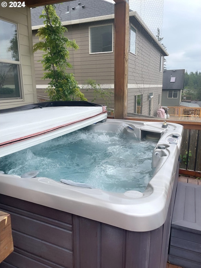 wooden deck with a hot tub