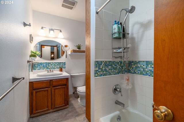 full bathroom featuring vanity, toilet, and tiled shower / bath