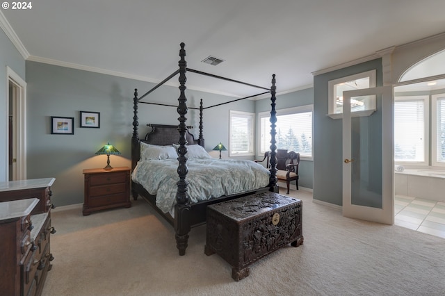 bedroom with multiple windows, light colored carpet, ensuite bathroom, and crown molding