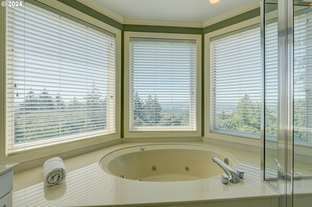 bathroom with ornamental molding, shower with separate bathtub, and vanity