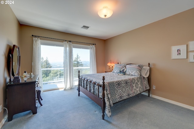 carpeted bedroom featuring access to outside