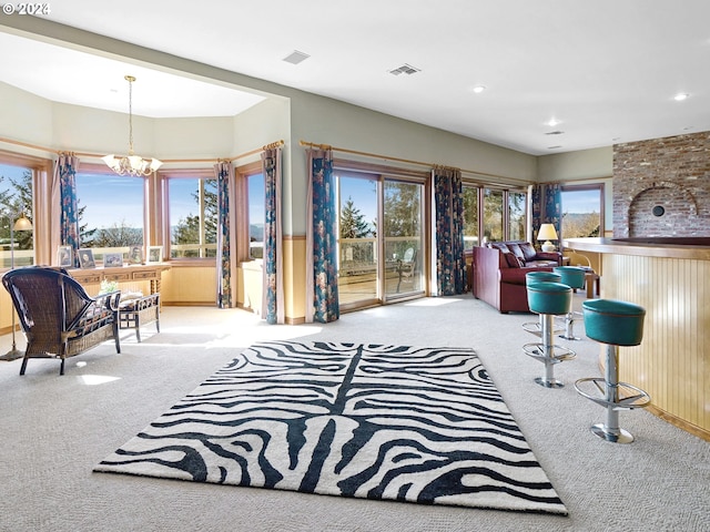 interior space featuring light colored carpet and a notable chandelier