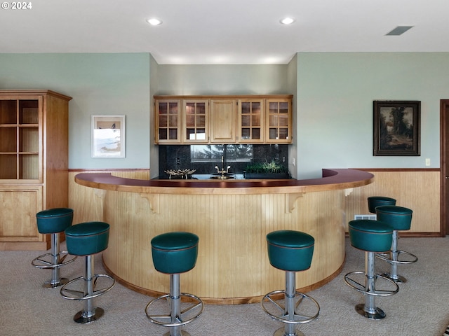 bar with light colored carpet and tasteful backsplash