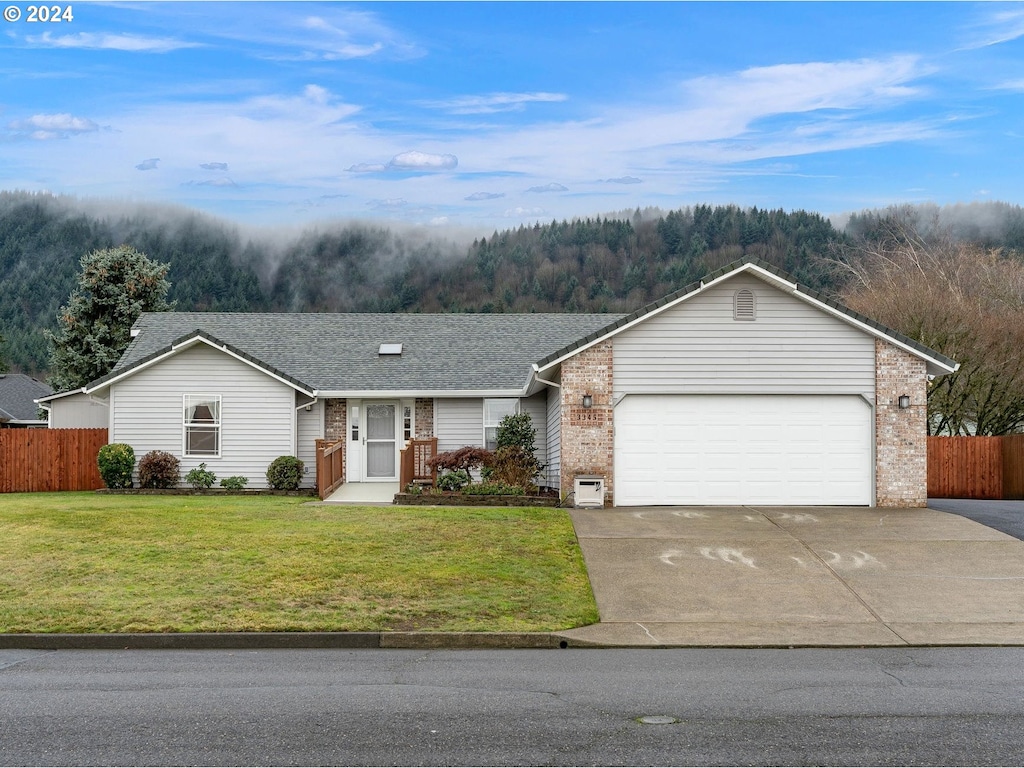 ranch-style house with a front yard and a garage