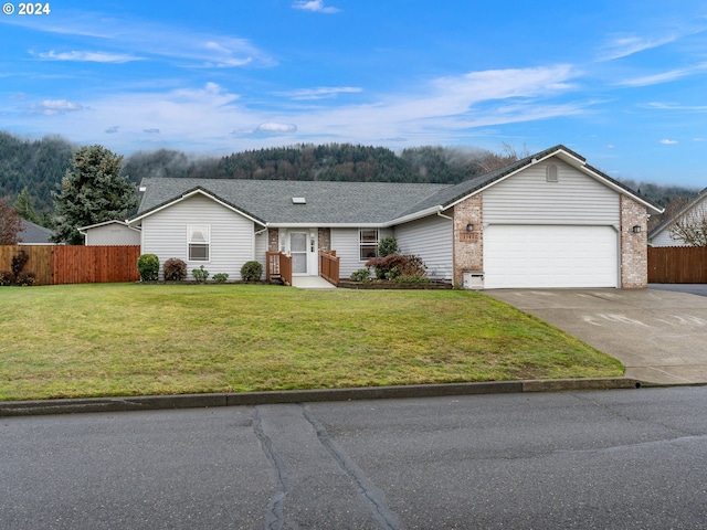 single story home with a garage and a front lawn