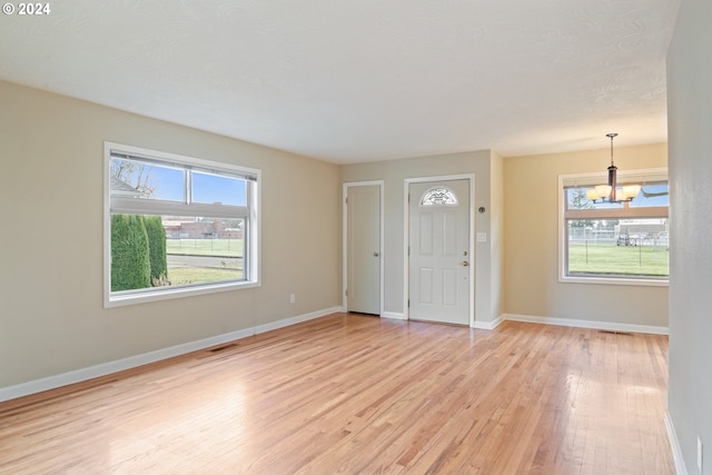 entryway featuring a notable chandelier and light hardwood / wood-style flooring