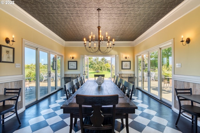 tiled dining area featuring a wealth of natural light, ornamental molding, and a chandelier