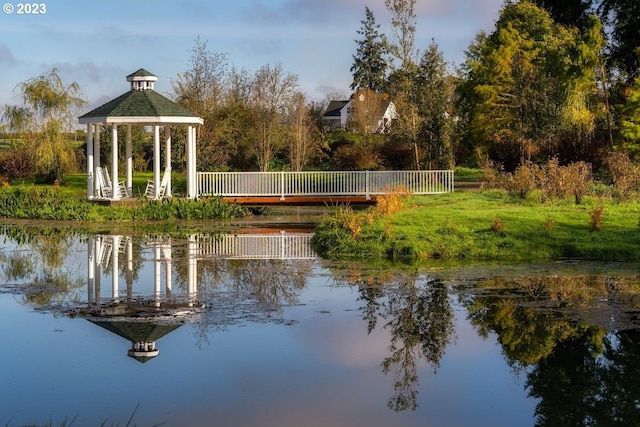 view of dock with a water view and a gazebo