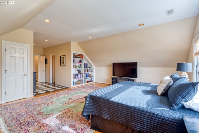 bedroom with vaulted ceiling and light tile floors