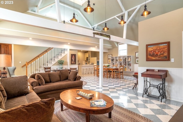 living room featuring tile flooring and a high ceiling