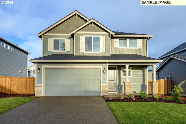 craftsman-style home with a garage and a front lawn