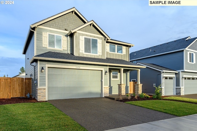 craftsman-style home with a front yard and a garage