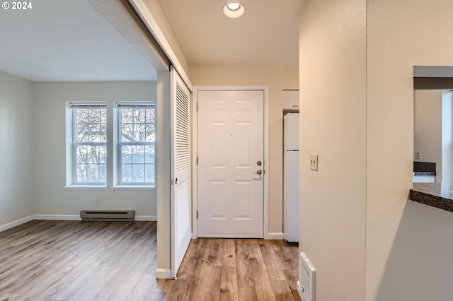 interior space featuring light hardwood / wood-style floors and a baseboard heating unit