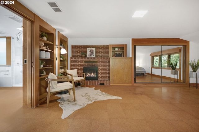 living area with built in shelves and a fireplace