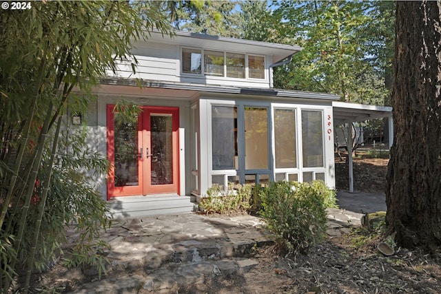 back of house featuring french doors, a sunroom, and a patio area