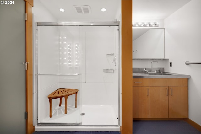 bathroom featuring vanity and an enclosed shower