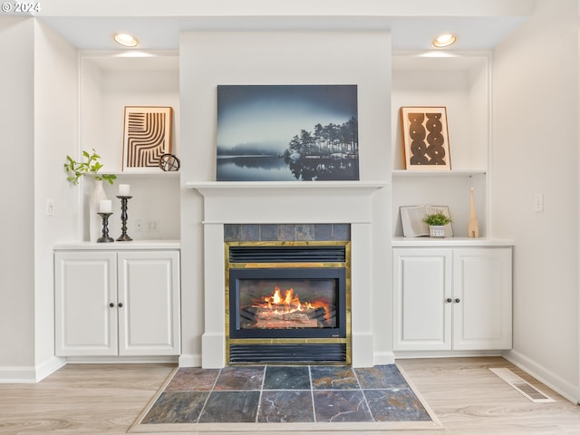 room details featuring hardwood / wood-style floors and a tile fireplace