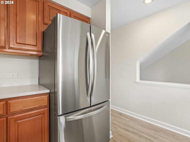 kitchen with light hardwood / wood-style floors and stainless steel fridge