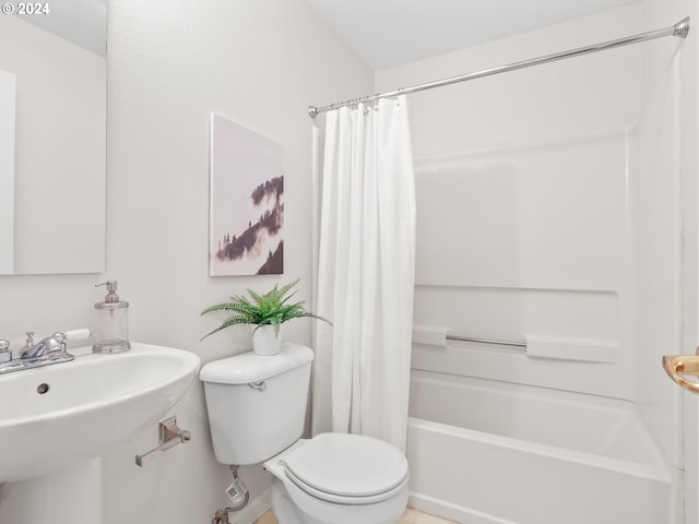 full bathroom with sink, shower / tub combo with curtain, and toilet