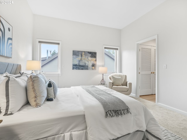 carpeted bedroom featuring multiple windows