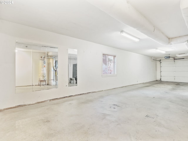 garage with a garage door opener and gas water heater