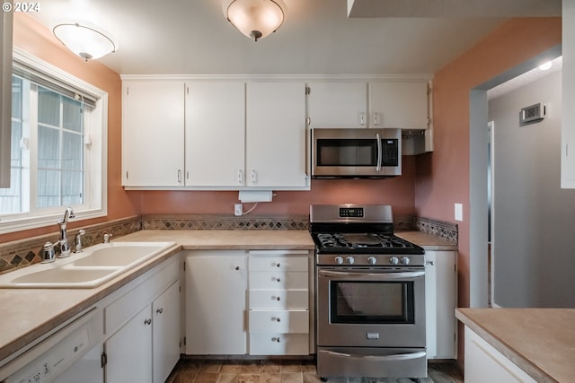 kitchen with white cabinets, sink, and stainless steel appliances