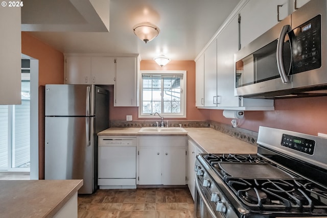 kitchen featuring white cabinetry, sink, and appliances with stainless steel finishes