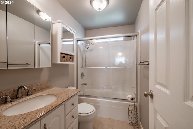 full bathroom featuring tile patterned flooring, vanity, toilet, and shower / bath combination with glass door