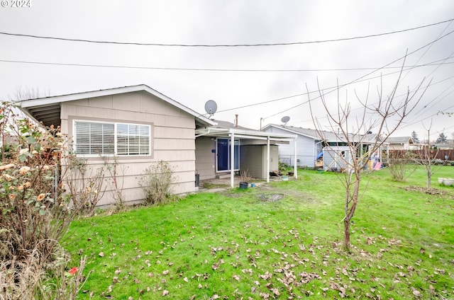 rear view of property featuring a yard