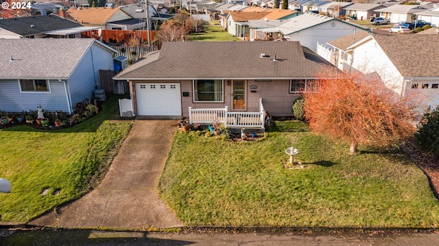 single story home featuring a front lawn, a porch, and a garage