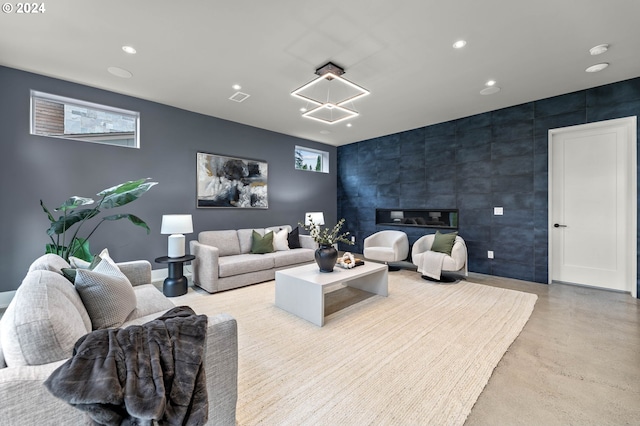 living room with a fireplace, plenty of natural light, and tile walls