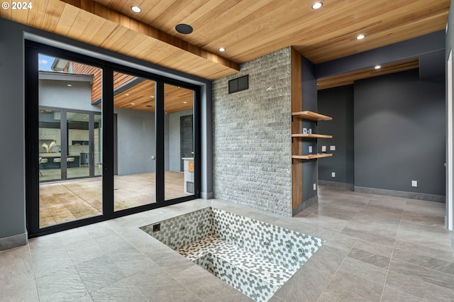 unfurnished room featuring plenty of natural light, expansive windows, and wooden ceiling