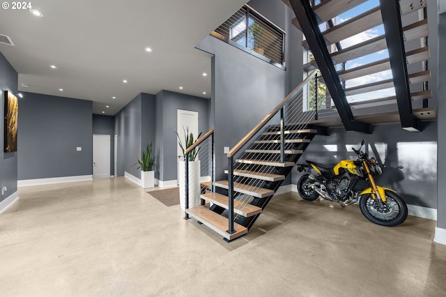 staircase with concrete flooring